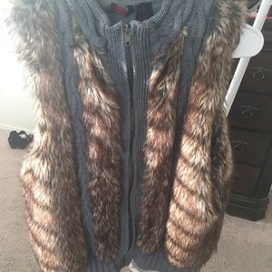 Grey fabric faux fur zip up vest.